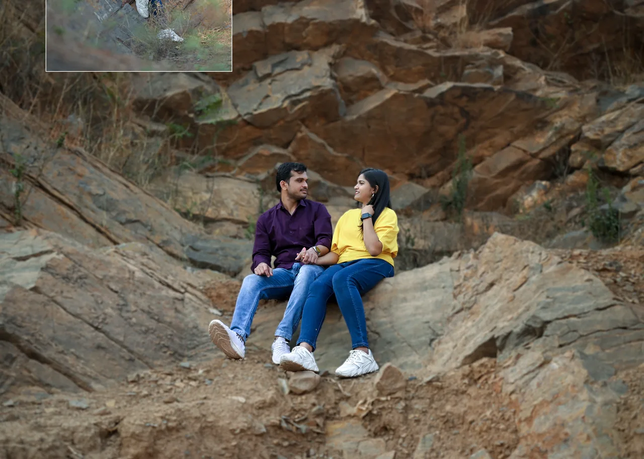 Couple sitting together on a rocky hillside
