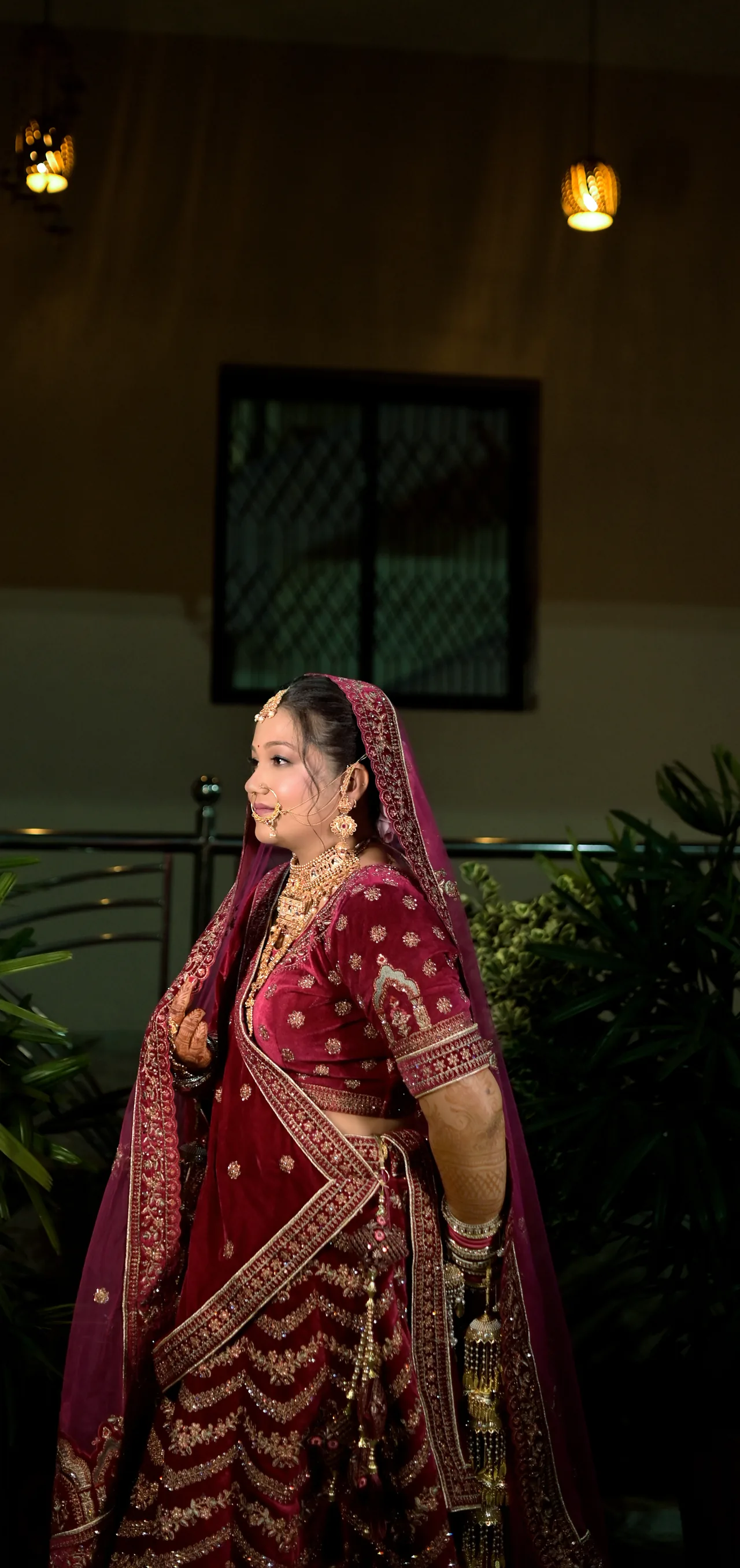 Bride in a maroon lehenga in evening light