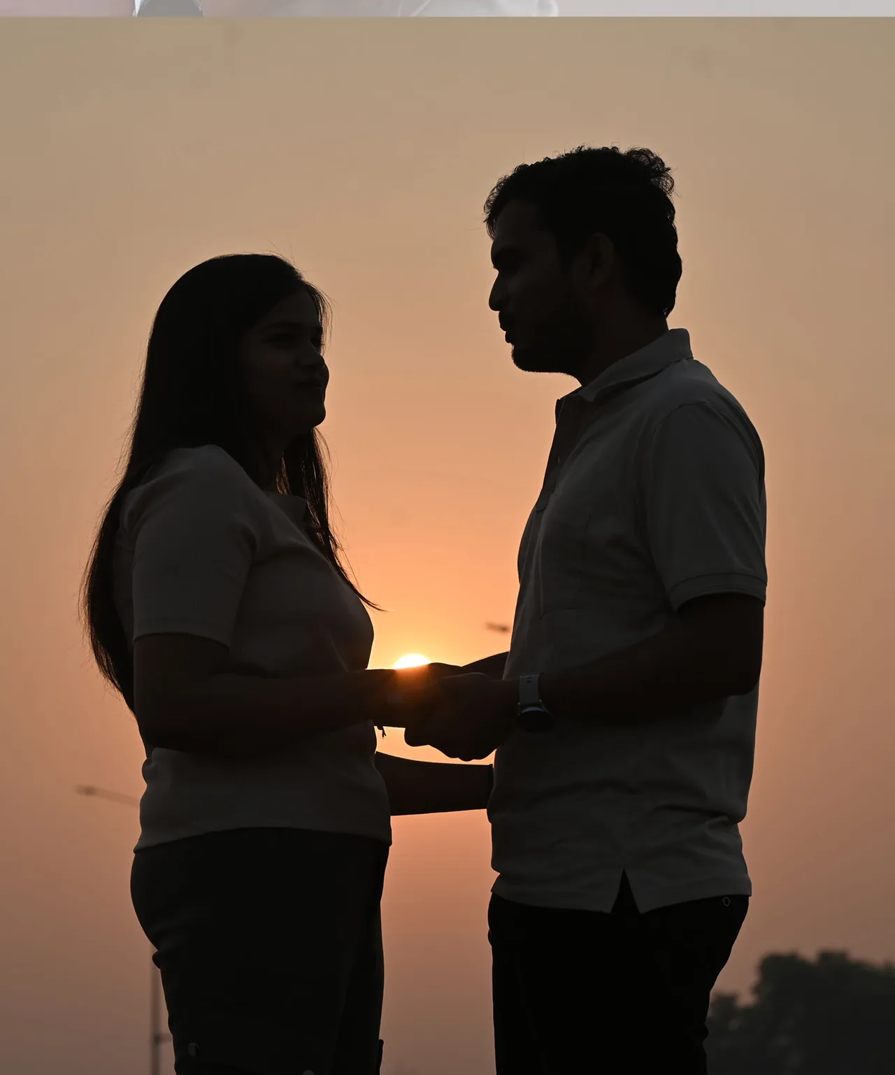 Couple silhouetted against the setting sun