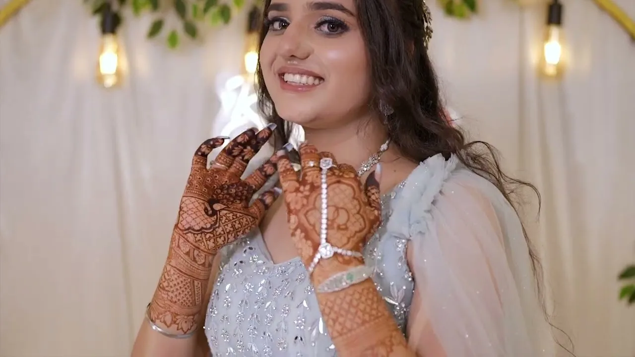Bride smiling and showing her mehendi-covered hands