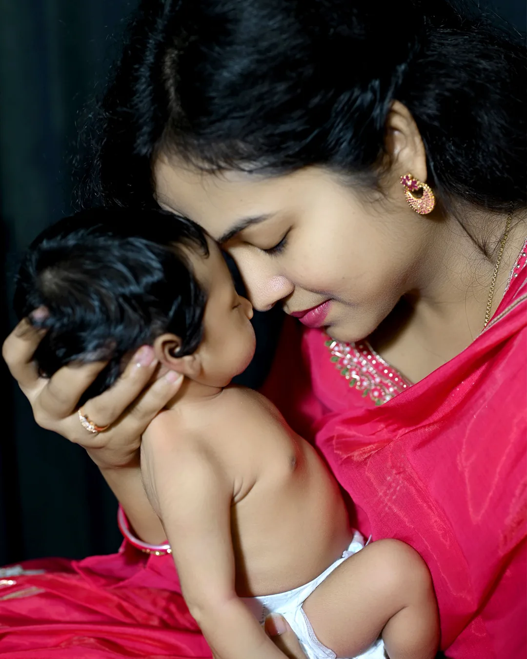 Mother cuddling her baby close