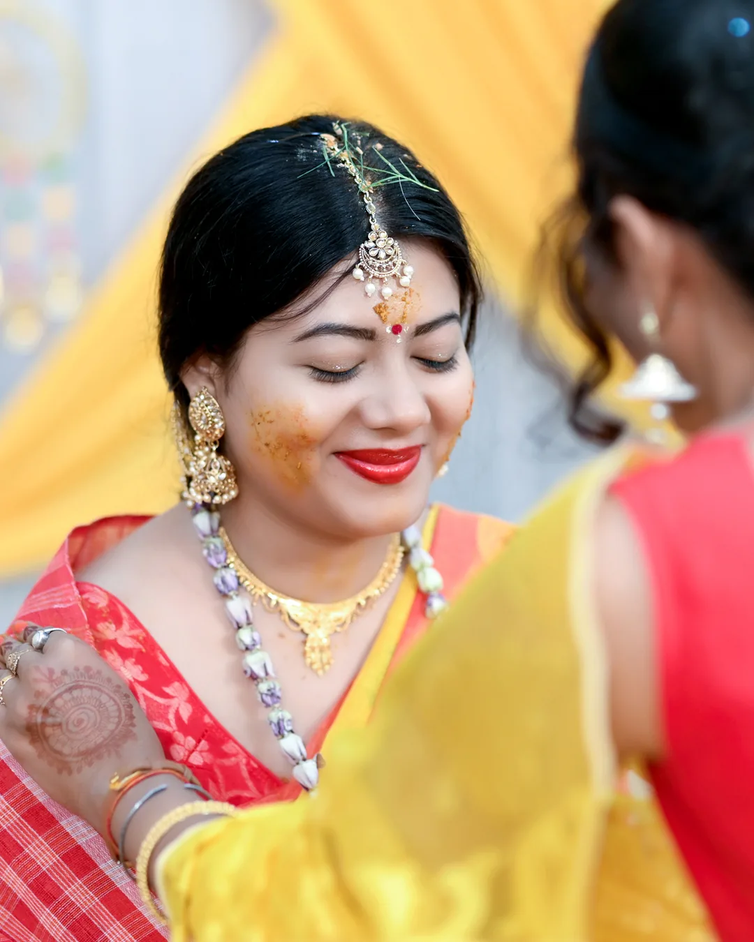 Bride laughing during her haldi ceremony
