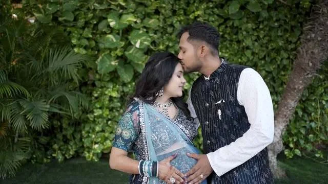 Expecting couple sharing a tender moment in a garden