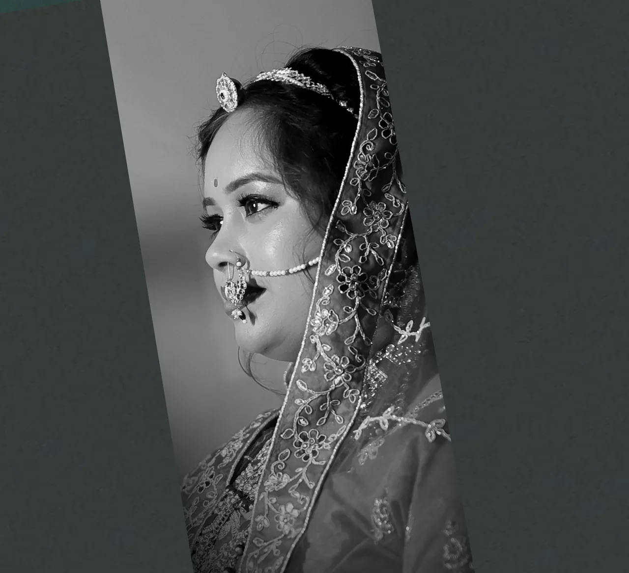 Black-and-white profile of a bride wearing a nath and embroidered dupatta